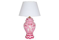 a pink lamp with a white shade on the base and a chevron pattern design