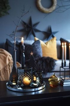 a living room with candles and decorations on the table