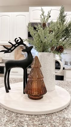 a kitchen counter top with a vase filled with pine cones and a deer figurine