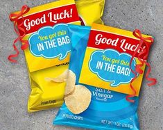 two bags of good luck potato chips sitting next to each other on the cement floor