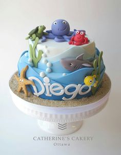 there is a cake with an ocean theme on the top and under it that says diego