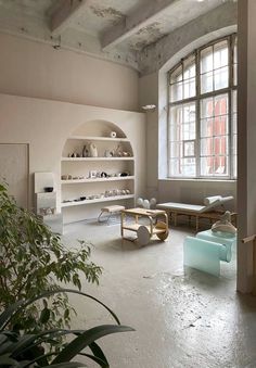 an empty room with lots of furniture and plants