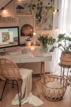 a home office with plants and pictures on the wall