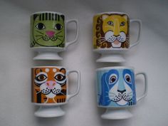 four coffee mugs with animals painted on them