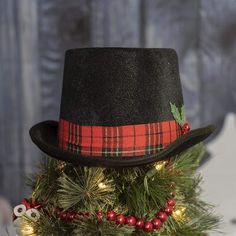 a small christmas tree with a top hat on it