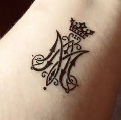 a tattoo with a crown on it