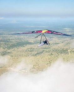 a man flying through the air on top of a parachute