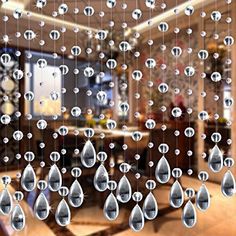 raindrops are hanging from the glass in front of a dining room table and couch