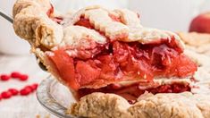 a close up of a piece of pie on a plate with cranberry sauce