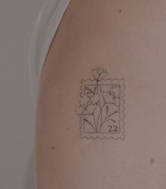 the back of a woman's shoulder with a stamp on it that has flowers