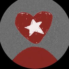 a red heart with a white star in the middle on a black and gray background