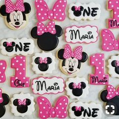 minnie mouse cookies are arranged in the shape of numbers for each child's first birthday