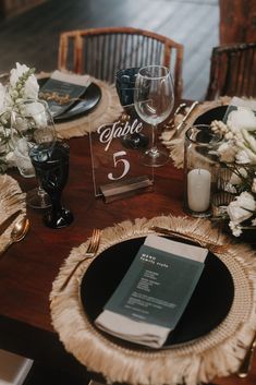 the table is set with place settings and flowers