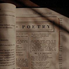 an open book with the words poetry on it's front page is shown in shadow