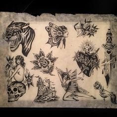 an old paper with tattoos on it and some drawings in the middle one is black