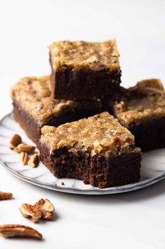 several pieces of brownie on a plate with nuts