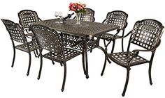 an outdoor dining table with six chairs and a wine glass on top of the table