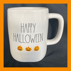 a white coffee mug with happy halloween written on it