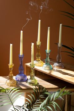 a group of candles sitting on top of a wooden table