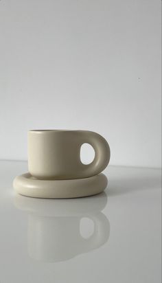 a white cup sitting on top of a table