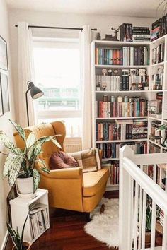 a living room filled with lots of books and furniture