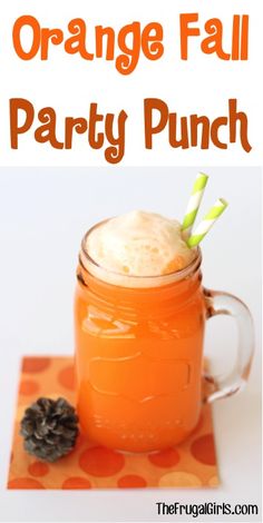 an orange party punch in a mason jar with pine cones on the side and text overlay