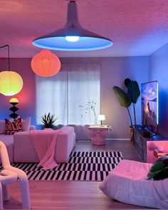 a living room filled with lots of furniture and lights on top of the ceiling above them