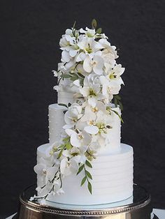 a wedding cake with white flowers on top