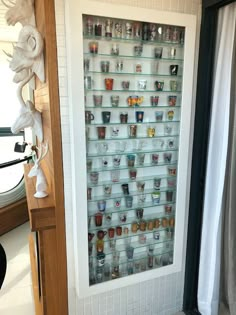 there is a display case with many cups on it