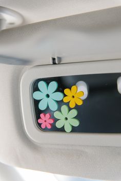 the flower stickers are on the side of the car door handle, which is decorated with multicolored flowers