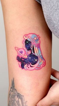 a woman's arm with a tattoo on it that has an image of a pony