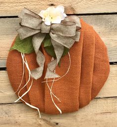 an orange pumpkin with a white flower on it