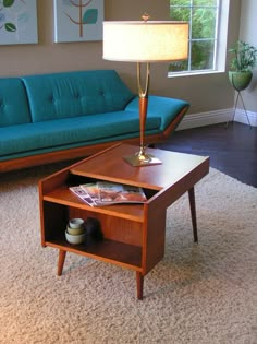 a living room with a couch, coffee table and lamp on the carpeted floor