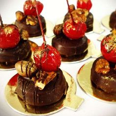 chocolate desserts with cherries and nuts on top