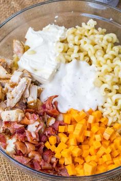 a bowl filled with macaroni and cheese, chicken, bacon, and sour cream