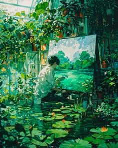 a man sitting in front of an easel painting water lilies