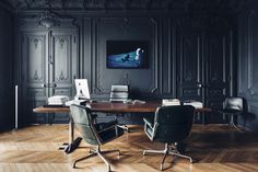 an empty conference room with black walls and wooden flooring is pictured in this image