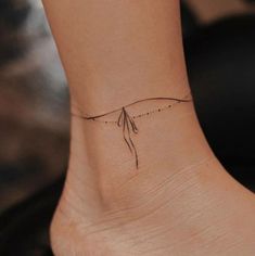 a woman's foot with a small tattoo on the side of her left ankle