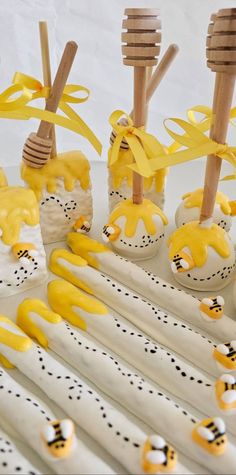 some yellow and white decorated desserts with wooden utensils