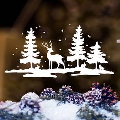 an image of a christmas scene with deer in the woods and snow on the ground