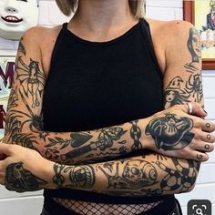 a woman with tattoos on her arm and arms