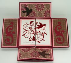 four square coasters with birds and flowers in red, brown, and beige colors