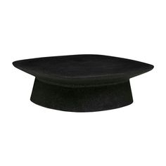 a black hat is sitting on top of a white surface and looks like it has been made out of felt