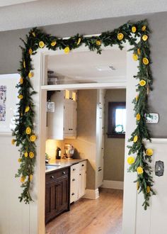 a kitchen decorated with yellow flowers and greenery is seen through an open doorway to the dining room