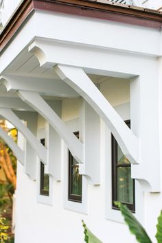 the corner of a white building with windows