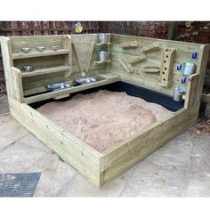 an outdoor sand pit made out of wooden pallets