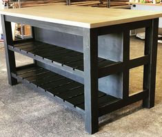 a kitchen island made out of wood and metal with shelves on each side for storage