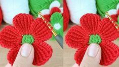 crocheted red flower with green center being held by someone's hand in front of them