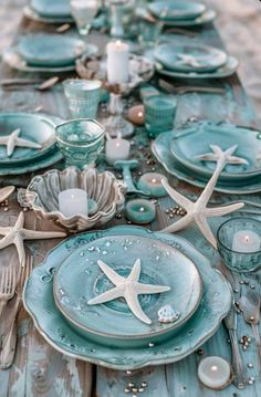 the table is set with starfish plates and silverware