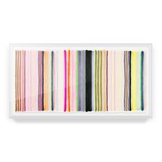 a white framed wall hanging with multicolored striped art on it's side